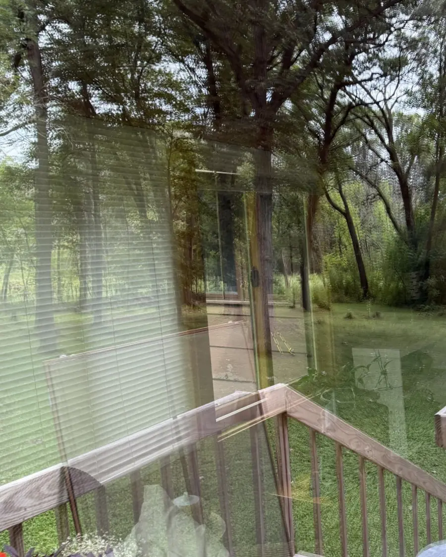 The same patio door with clear glass and a sharp view of the deck and yard